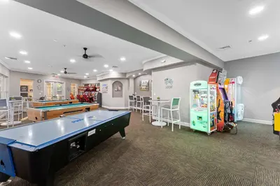 a large room with a pool table and some games at Windsor Hills Resort 2Bd with Great Amenities in Orlando