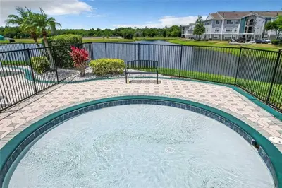 a swimming pool with a bench in a yard at Playing Hooky in Kissimmee
