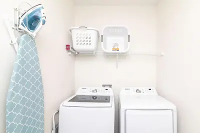a small laundry room with a washer and dryer at Rum Runners and Margaritas in Orlando