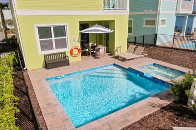 a swimming pool in front of a house at Rum Runners and Margaritas in Orlando