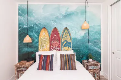 a bedroom with a bunch of surfboards on the wall at Rum Runners and Margaritas in Orlando