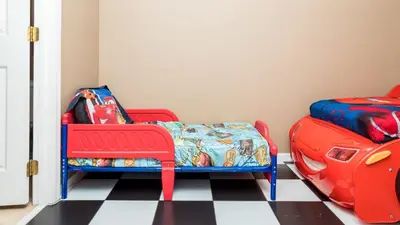 a childs room with a red chair and a toy car at Serendipity at Acadia - Family getaway in Orlando