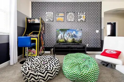 a living room with a couch and a tv at Storeybook Escape - Sleeps 11 in Kissimmee