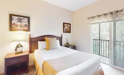 a bedroom with a large bed and a window at Sunny Haven At Caribe Cove in Kissimmee