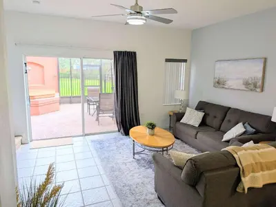 a living room with a couch and a table at Terra Verde - Resort Amenities & More in Kissimmee