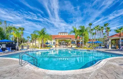 a swimming pool at a resort with palm trees at Terra Verde - Resort Amenities & More in Kissimmee