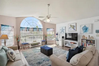 a living room with a couch and a tv at 2466 Sweetwater in Kissimmee