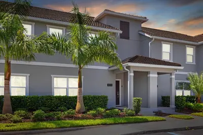 a house with palm trees in front of it at 4 Bedrooms - 3 Bathrooms - Storey Lake 4818Ml in Kissimmee