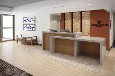 an office lobby with a reception desk and chairs at Candlewood Suites Orlando North - Winter Park by IHG in Orlando