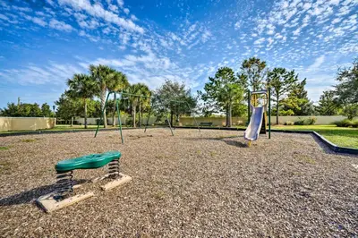 a playground with two swings and a swing at 4 Mi to WDW Sleek Townhome with Community Pool! in Kissimmee