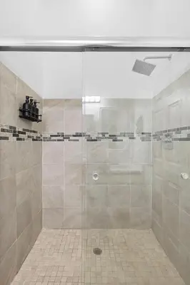 a shower with a glass door in a bathroom at Enjoy your Summer Near to Disney- Universal-Epic in Kissimmee
