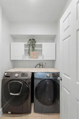 a washer and dryer in a kitchen with a door at Enjoy your Summer Near to Disney- Universal-Epic in Kissimmee