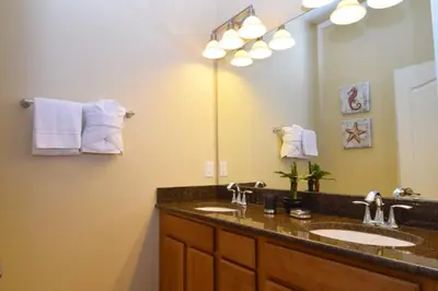 a bathroom with two sinks and a large mirror at Fully Equipped Comfortable Townhouse in Kissimmee