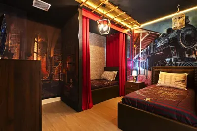 a room with a bed and a train wall at Magical 15-Bedroom Villa | Game Room, Theater & More! in Kissimmee