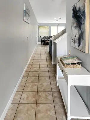 a hallway with a tile floor in a house at Rumi Haven-Homey&Spacious Stay in Orlando