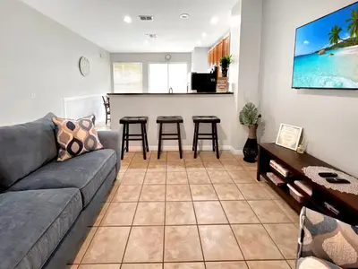 a living room with a couch and a table at Rumi Haven-Homey&Spacious Stay in Orlando