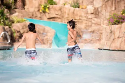 two young boys playing in the water at a water park at Universal's Loews Sapphire Falls Resort in Orlando