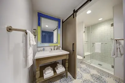 a bathroom with a sink and a shower at Universal's Loews Sapphire Falls Resort in Orlando