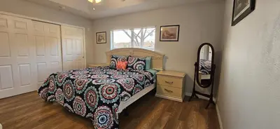 a bedroom with a bed and a dresser and a mirror at SHVPC3 - Paradise Cay #3 - 3 Bed 2.5 Baths Townhome in Kissimmee