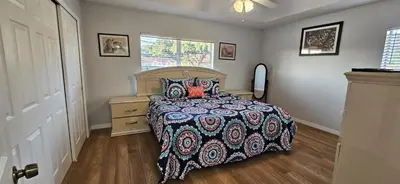 a bedroom with a bed and a dresser and a window at SHVPC3 - Paradise Cay #3 - 3 Bed 2.5 Baths Townhome in Kissimmee