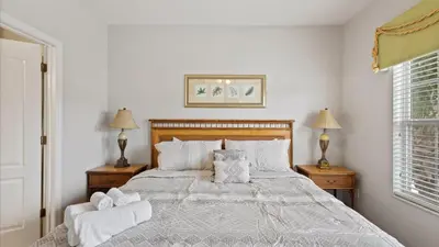 a bedroom with a large bed with two night stands at SHVCK1 - Coral Cay Resort #1 - 4 Bedroom Townhouse in Kissimmee