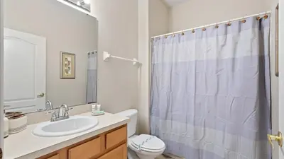 a bathroom with a sink and a toilet and a shower at SHVCK3 - Coral Cay Resort #3 - 4 Bed 3 Baths Townhome in Kissimmee