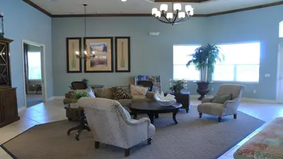 a living room with a couch and a table and chairs at SHVCK4 - Coral Cay Resort #4 - 4 Bed 3 Baths Townhome in Kissimmee