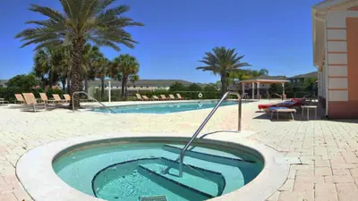 a swimming pool with a hot tub in a resort at SHVCK5 - Coral Cay Resort #5 - 4 Bed 3 Baths Townhome in Kissimmee