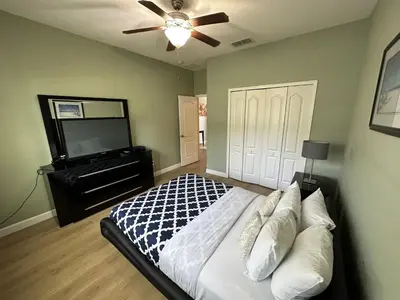 a bedroom with a bed with a ceiling fan and a piano at SHVPP1 - Paradise Palms #1 - 6 Bed 5 Baths Villa in Kissimmee
