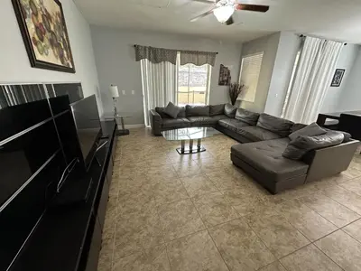 a living room with a couch and a table at SHVPP1 - Paradise Palms #1 - 6 Bed 5 Baths Villa in Kissimmee