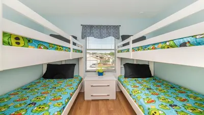 a bedroom with two bunk beds and a window at SHVCC1 - Crystal Cove #1 - 7 Bed 4.5 Baths Villa in Kissimmee