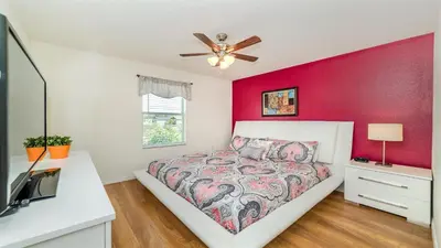 a bedroom with a bed and a ceiling fan at SHVCC2 - Crystal Cove #2 - 7 Bed 4.5 Baths Villa in Kissimmee