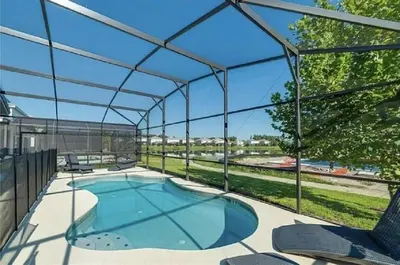 an overhead view of a swimming pool under a pergola at Luxury Family Villa With Pool & Bbq Near Disney! in Kissimmee