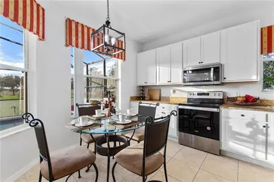 a kitchen with a table and chairs in a kitchen at 4Br Pool Villa, Near Disney - Gated Resort! in Kissimmee