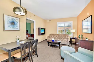 a living room with a couch and a table at 2 Queen BR Condo Near Universal with Hot Tub & Pool in Orlando