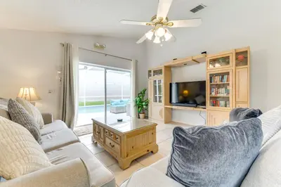 a living room with two couches and a tv at 4 Mi to Disney Home with Pool Table, Outdoor Oasis! in Orlando