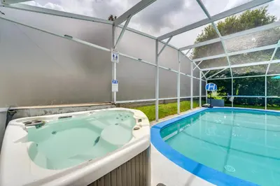 a swimming pool with a hot tub in a building at 4 Mi to Disney Home with Pool Table, Outdoor Oasis! in Orlando