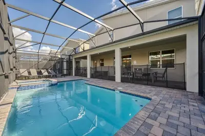 an indoor swimming pool with a glass roof over a house at Casa9 quartos p/ família+Temas c/ piscina in Kissimmee