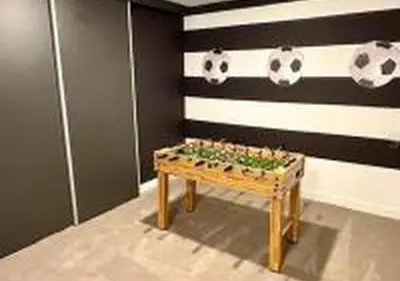a room with a table with soccer balls on the wall at 3231 ED - The Hub Modern 3BR in Kissimmee