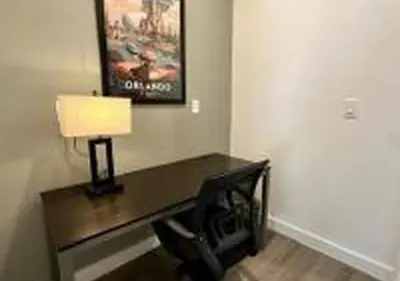 a desk in a room with a lamp on it at 3231 ED - The Hub Modern 3BR in Kissimmee