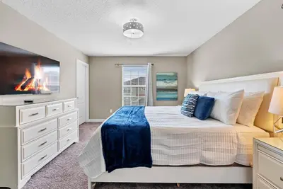 a bedroom with a bed and a tv at Amazing 06 Bedrooms3 BathSleeps 14 in Kissimmee