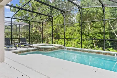 an indoor swimming pool with a glass house at Amazing 06 Bedrooms3 BathSleeps 14 in Kissimmee
