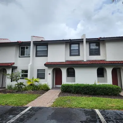 a white house with a red roof at Family vacation Villa in Fantasy World Resort - Minutes from Disney in Kissimmee