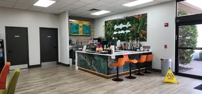 a bar in a restaurant with orange chairs at Family vacation Villa in Fantasy World Resort - Minutes from Disney in Kissimmee