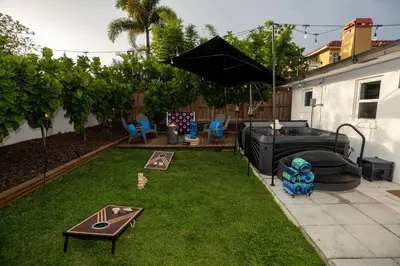 a backyard with a lawn with a trampoline at Historic Retreat on Eola + Private Hot Tub + Grill in Orlando
