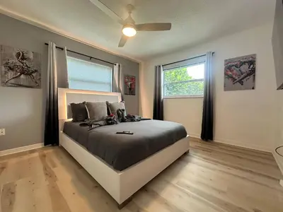 a bedroom with a bed and a ceiling fan at Historic Retreat on Eola + Private Hot Tub + Grill in Orlando