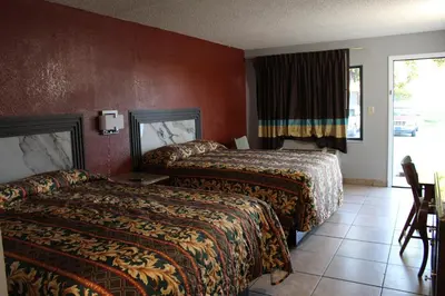 a hotel room with two beds and a window at Oak Ridge Inn in Kissimmee