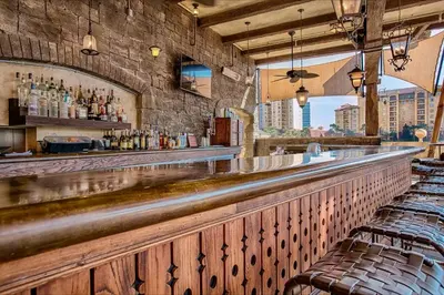 a bar with a long counter and some chairs at Wyndham Bonnet Creek 1BR Apartment with Resort Access in Orlando