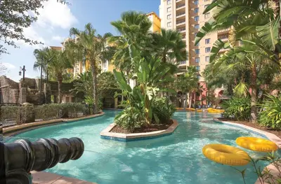 a large swimming pool in a city with palm trees at Wyndham Bonnet Creek 2BR Apartment with Resort Access in Orlando