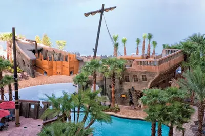 a resort with a swimming pool and palm trees at Wyndham Bonnet Creek 3BR Apartment with Resort Access in Orlando